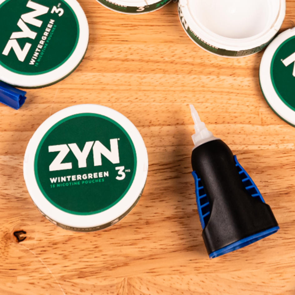 Wintergreen ZYN cans on a wooden table.