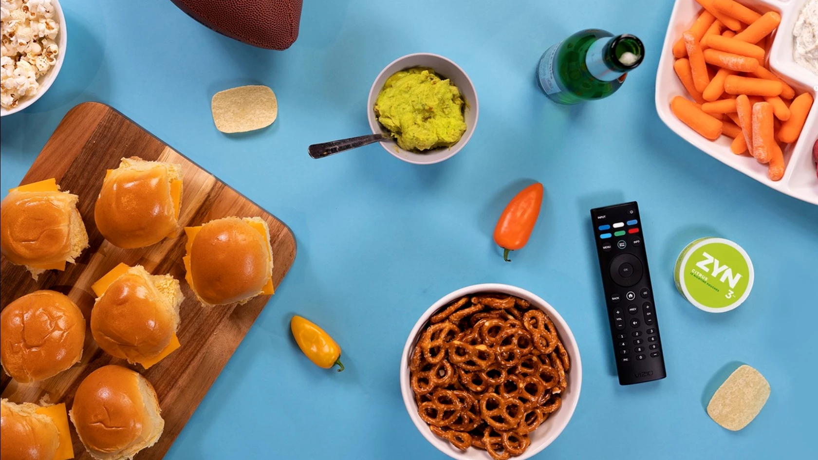 A can of cirtus ZYN on a blue table with various bbq food items. 