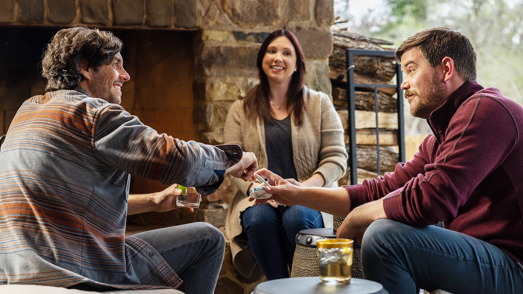 A group of young adults sitting around sharing a can of ZYN classic. 