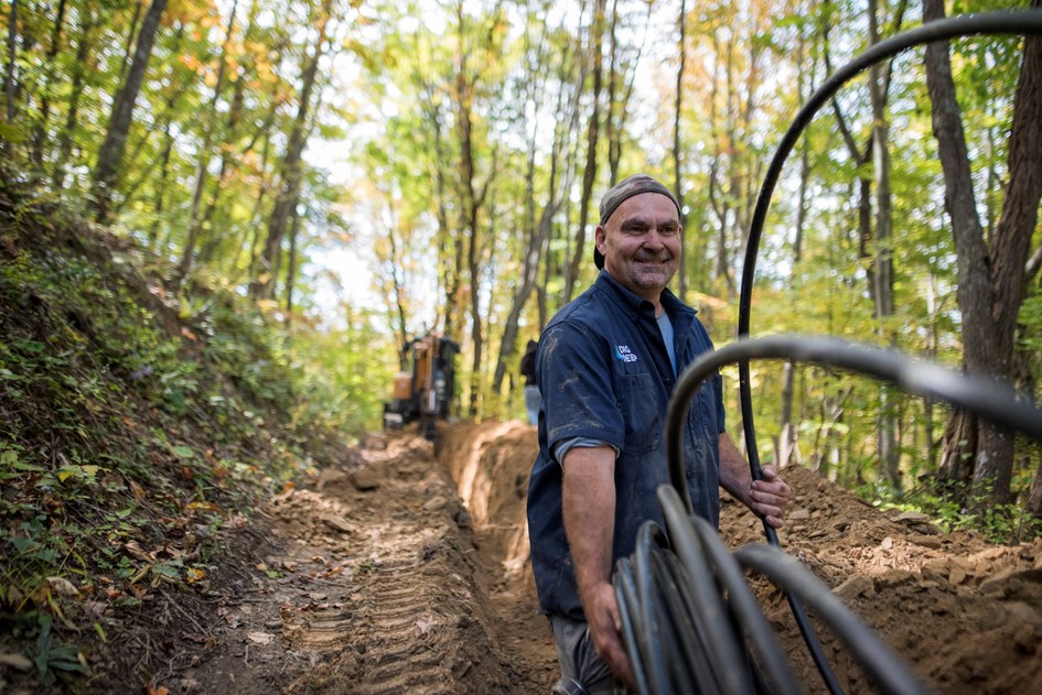 Man Smiling Running Pipe Connections