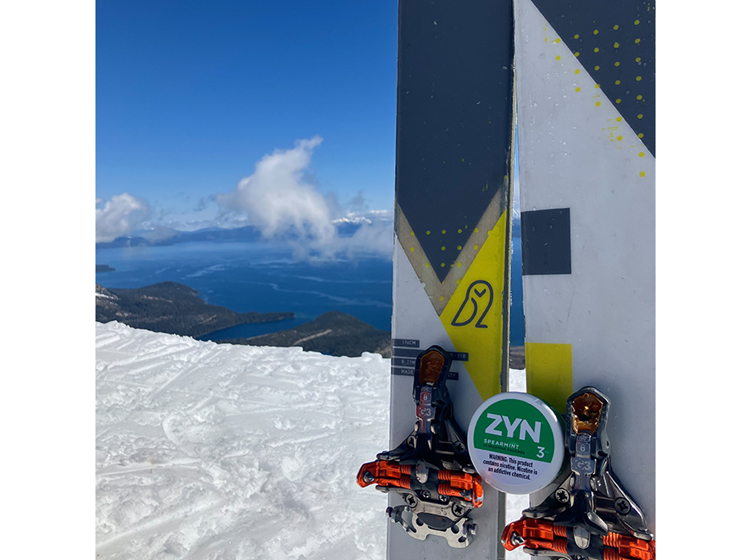 ZYN Across America winning submission of a spearmint 3 ZYN can nestled on a set of skis' on the top of a mountain.